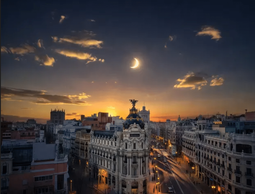 Spain Eclipse 2026 The Ultimate Guide 2 Metropolis Building and Gran Vía are illuminated by a surreal twilight glow