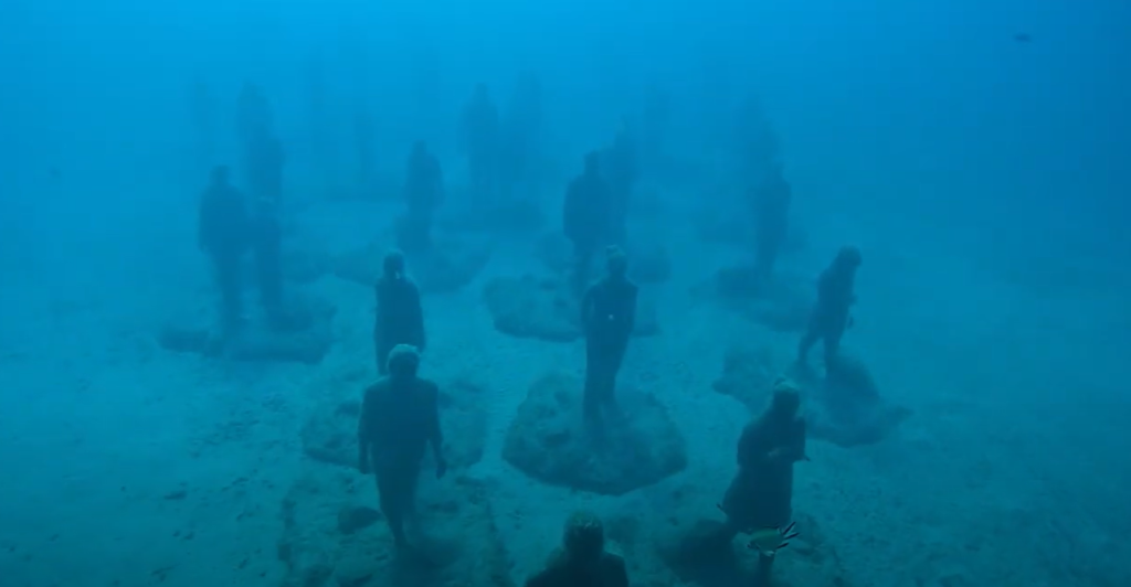 The Rubicon – 35 life-sized figures walking toward a wall,